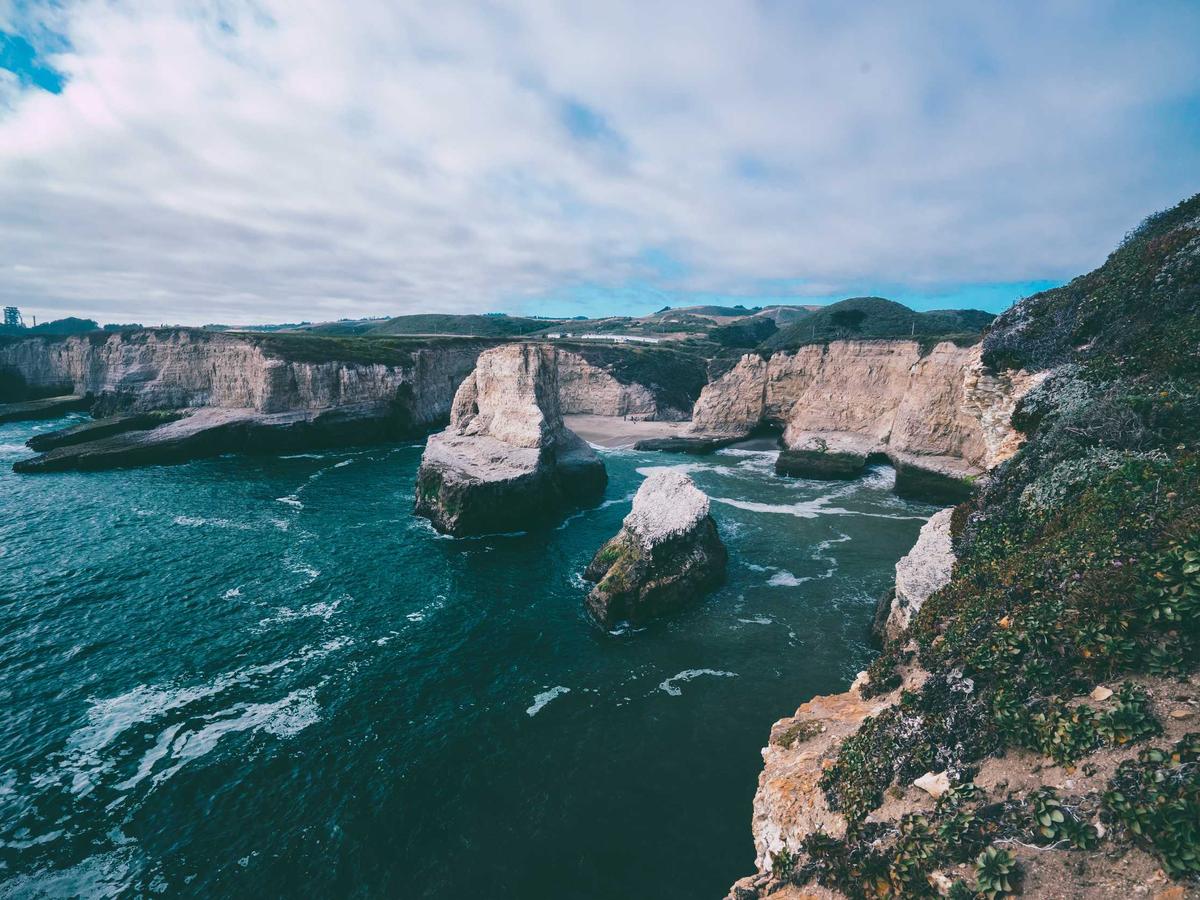 Bright coastal cliffs and clear turquoise water